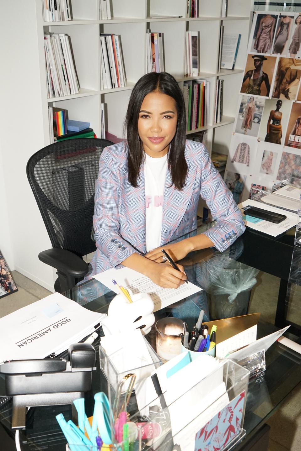 Emma Grede sitting at a desk